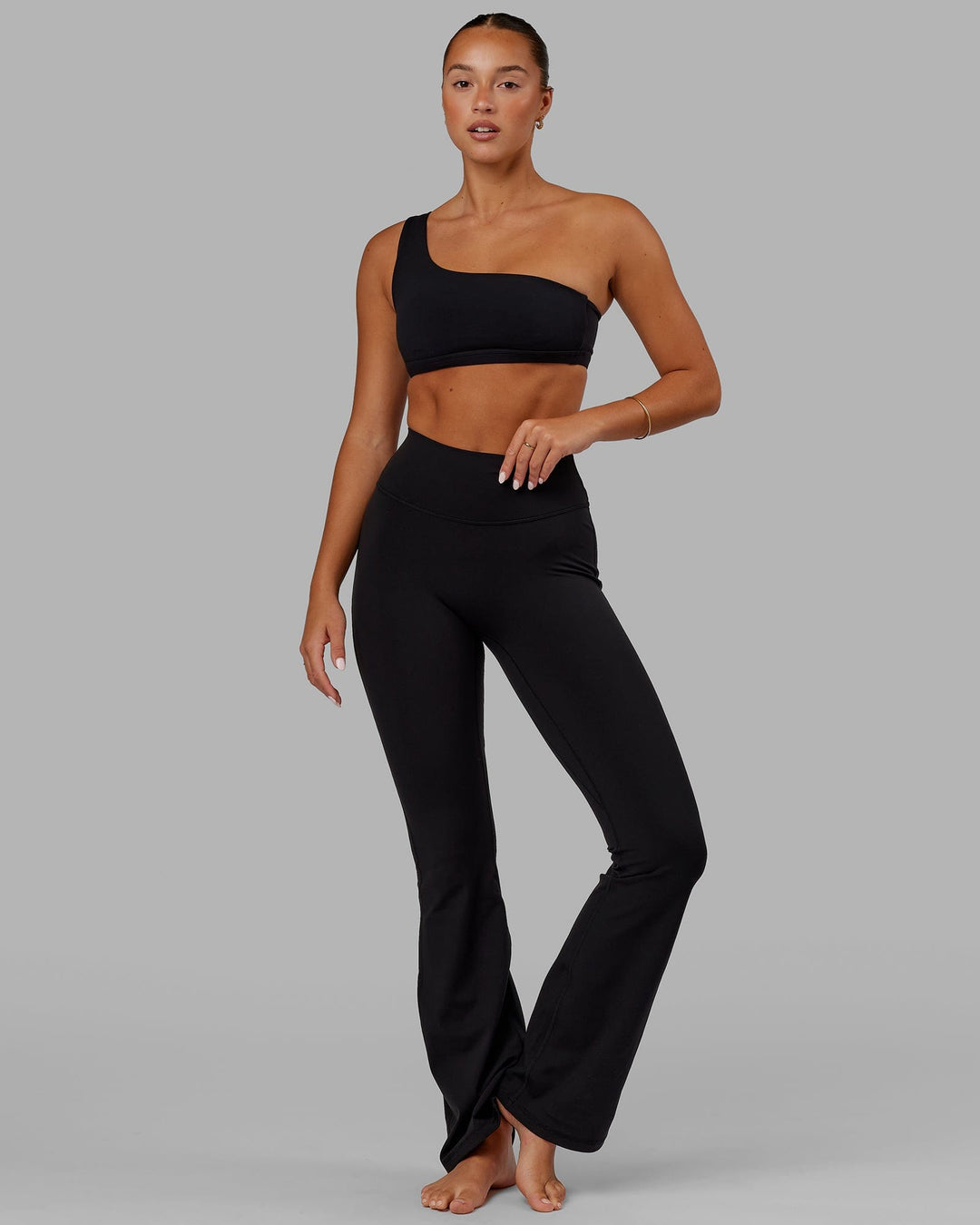Woman wearing Fusion Ultra High-Rise Flared Legging - Black | Model:Milly | Size:S
