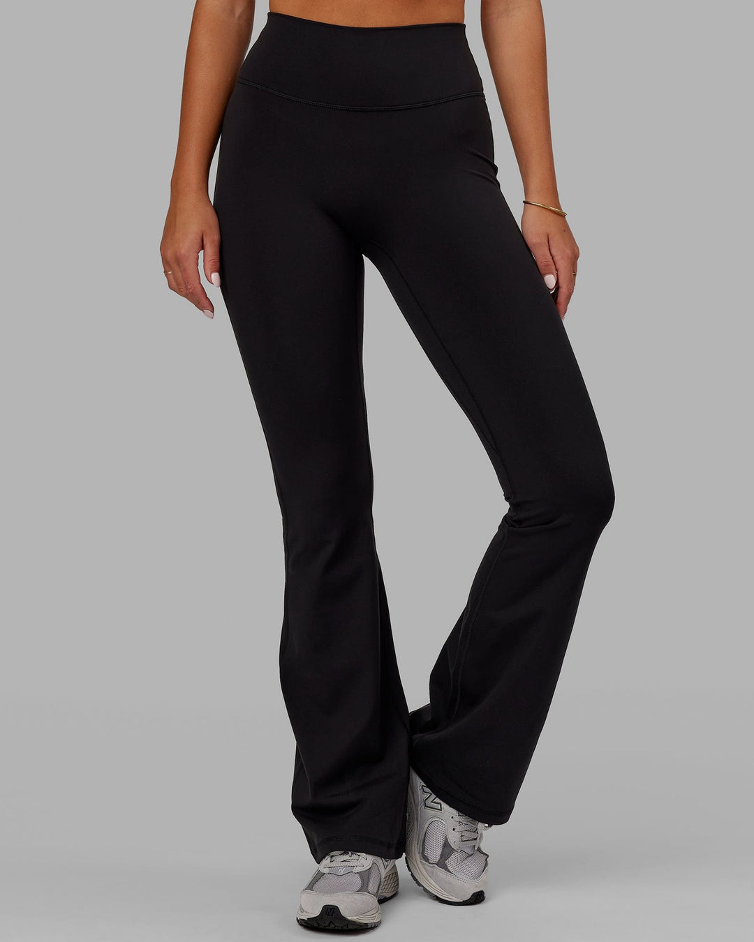 Woman wearing Fusion Ultra High-Rise Flared Legging - Black | Model:Milly | Size:S