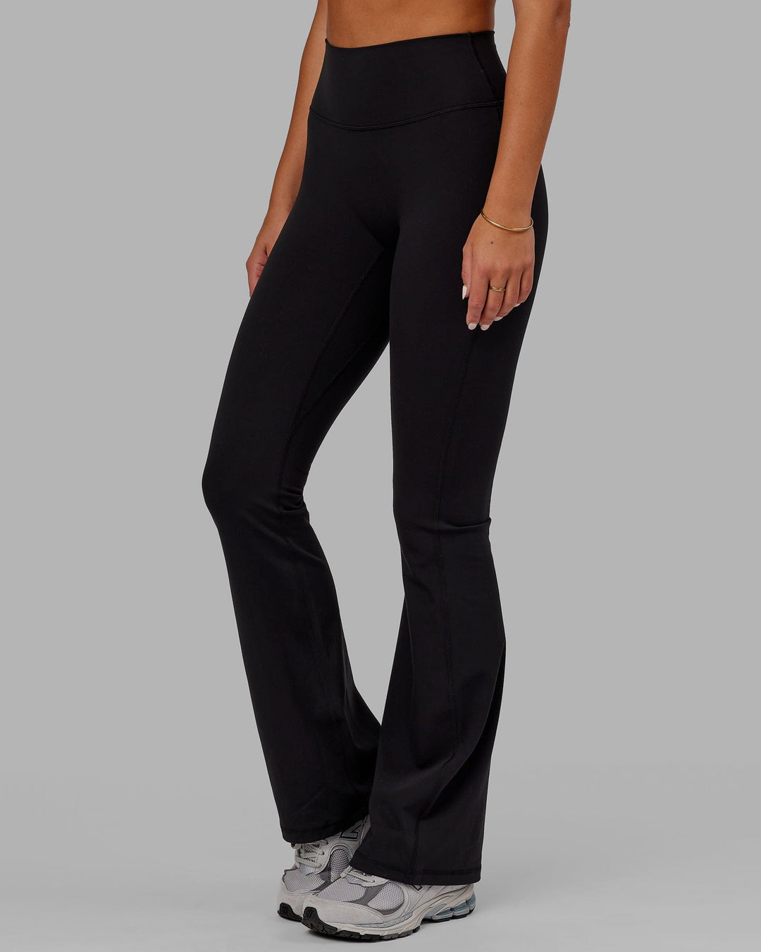 Woman wearing Fusion Ultra High-Rise Flared Legging - Black | Model:Milly | Size:S