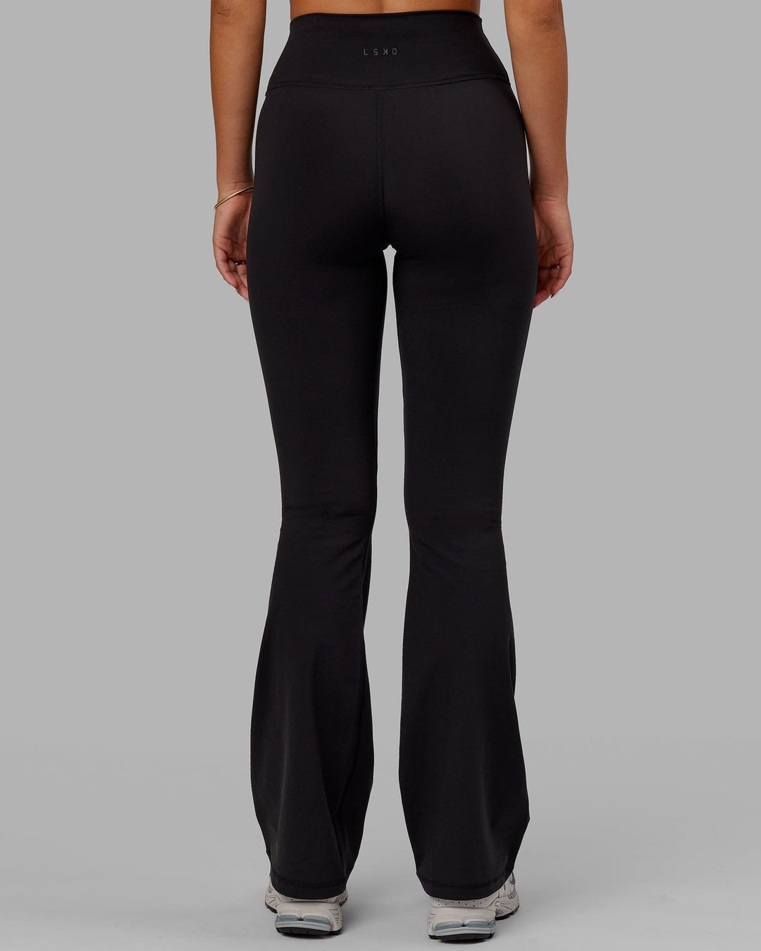 Woman wearing Fusion Ultra High-Rise Flared Legging - Black | Model:Milly | Size:S