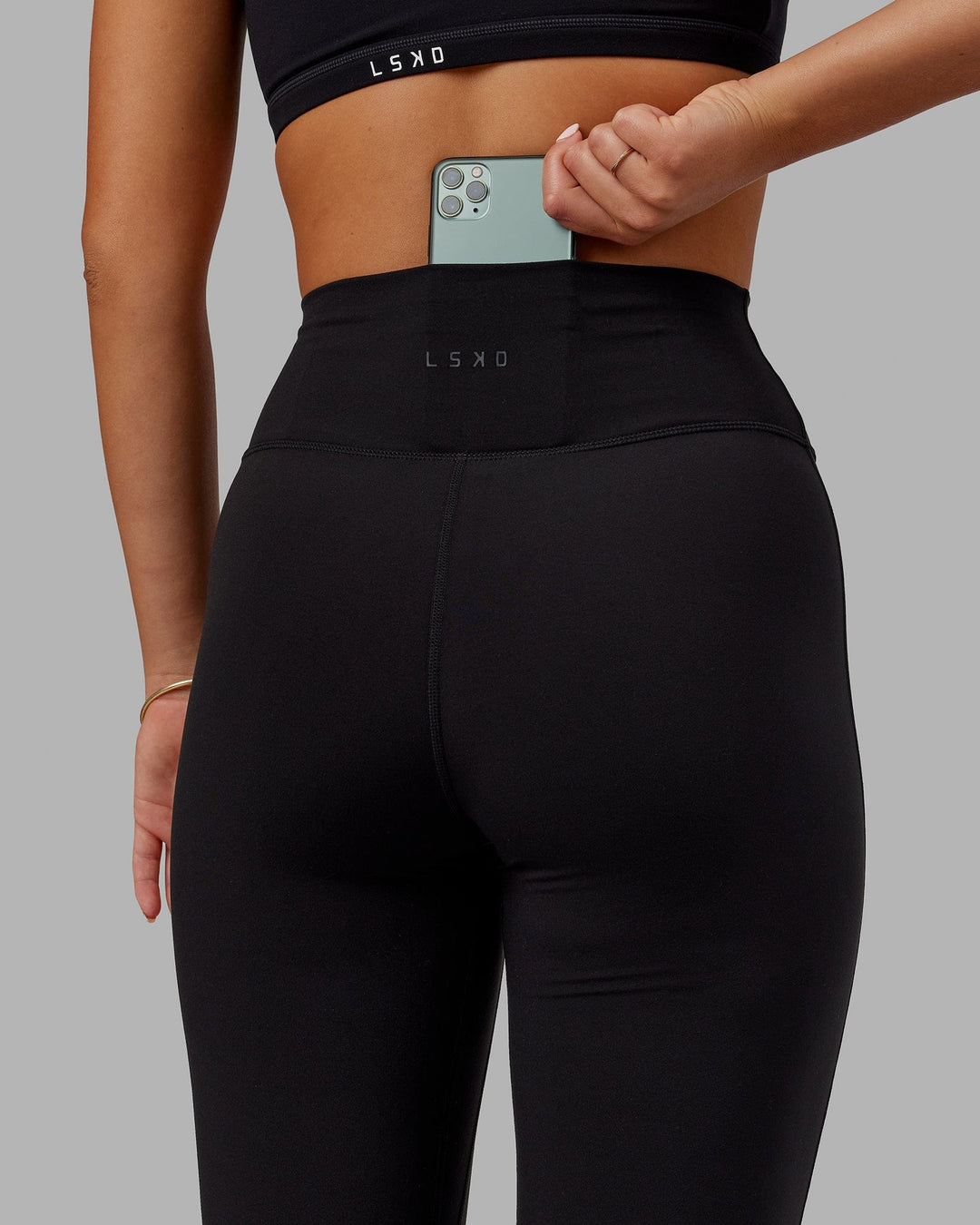 Woman wearing Fusion Ultra High-Rise Flared Legging - Black | Model:Milly | Size:S