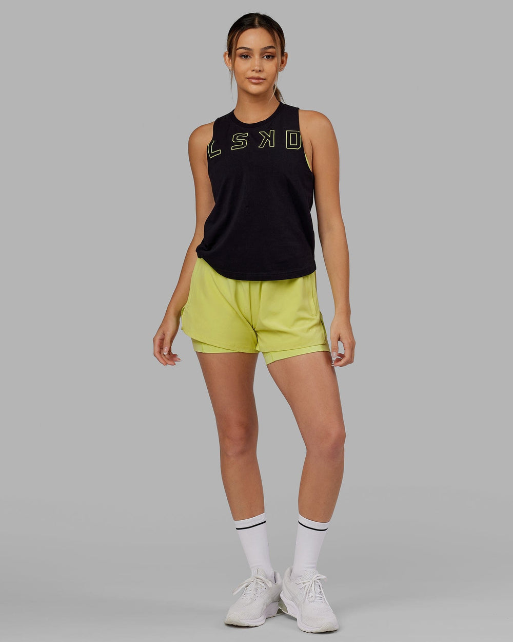 Woman wearing Expand FLXCotton Tank - Black-Citrus Green