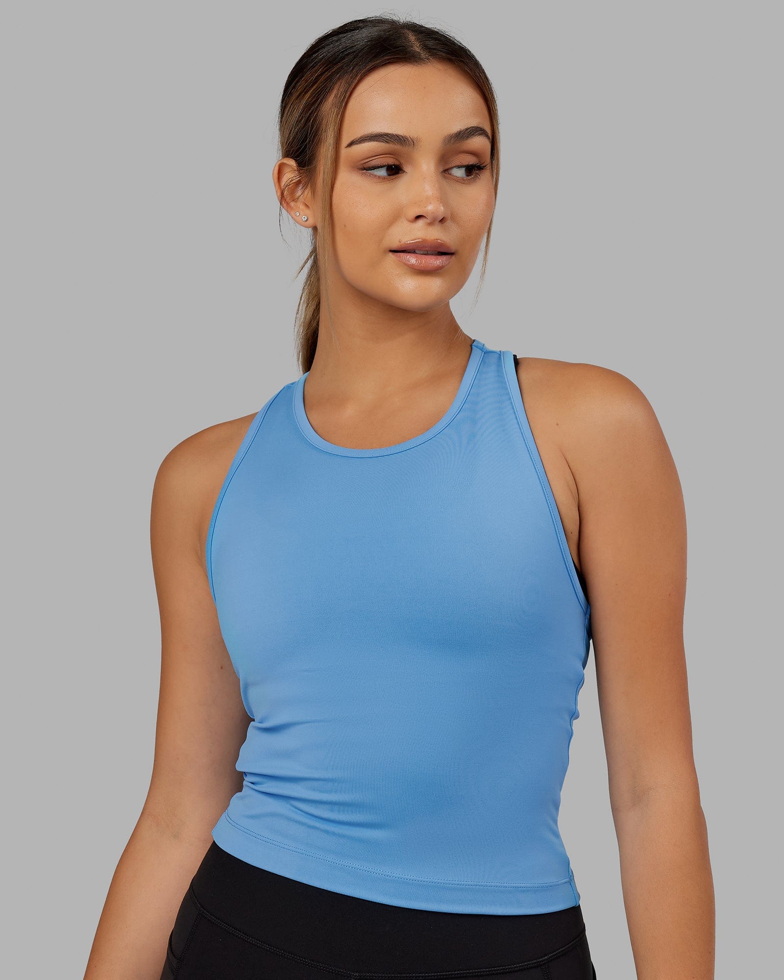 Woman wearing Flow Performance Tank - Azure Blue