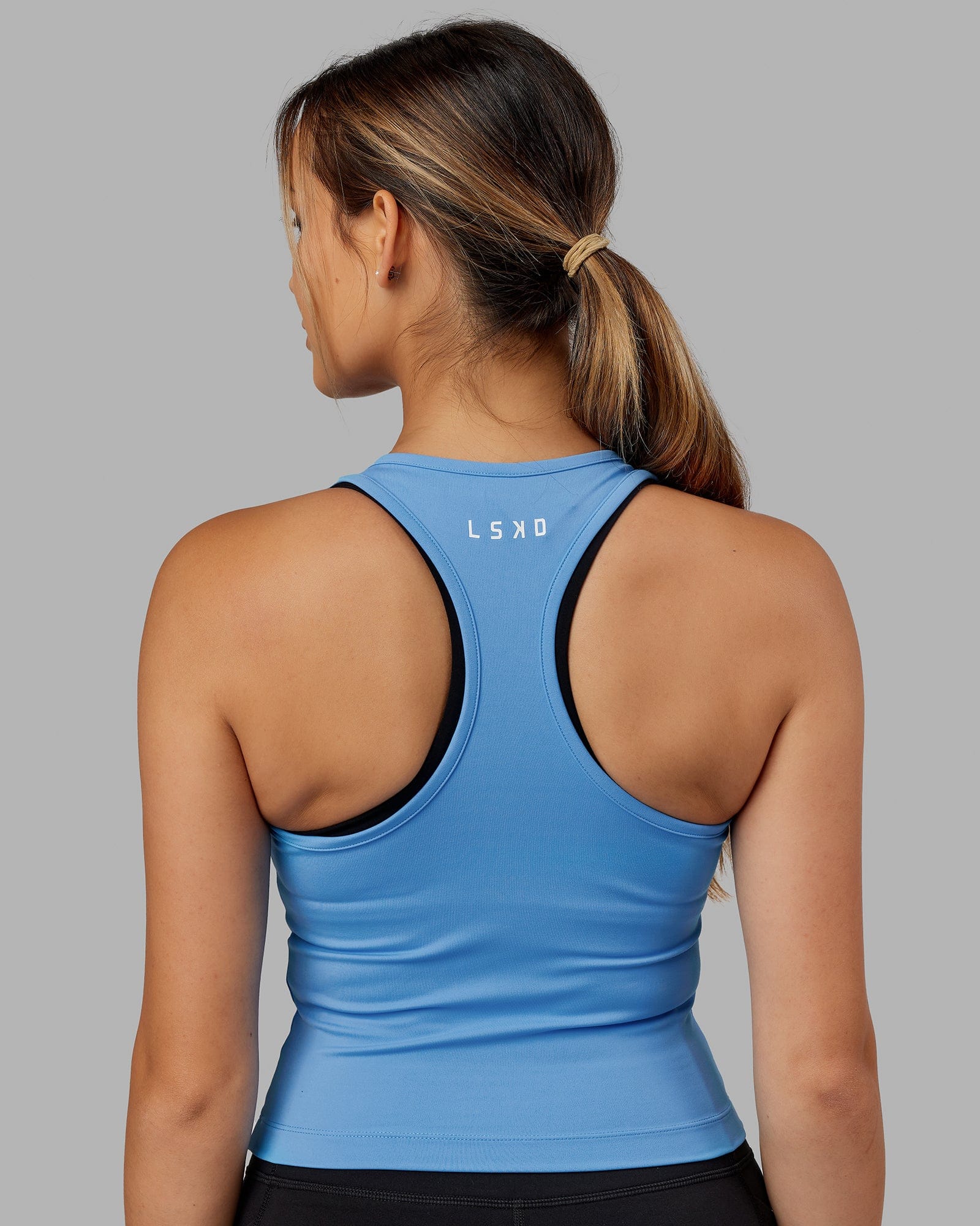 Woman wearing Flow Performance Tank - Azure Blue