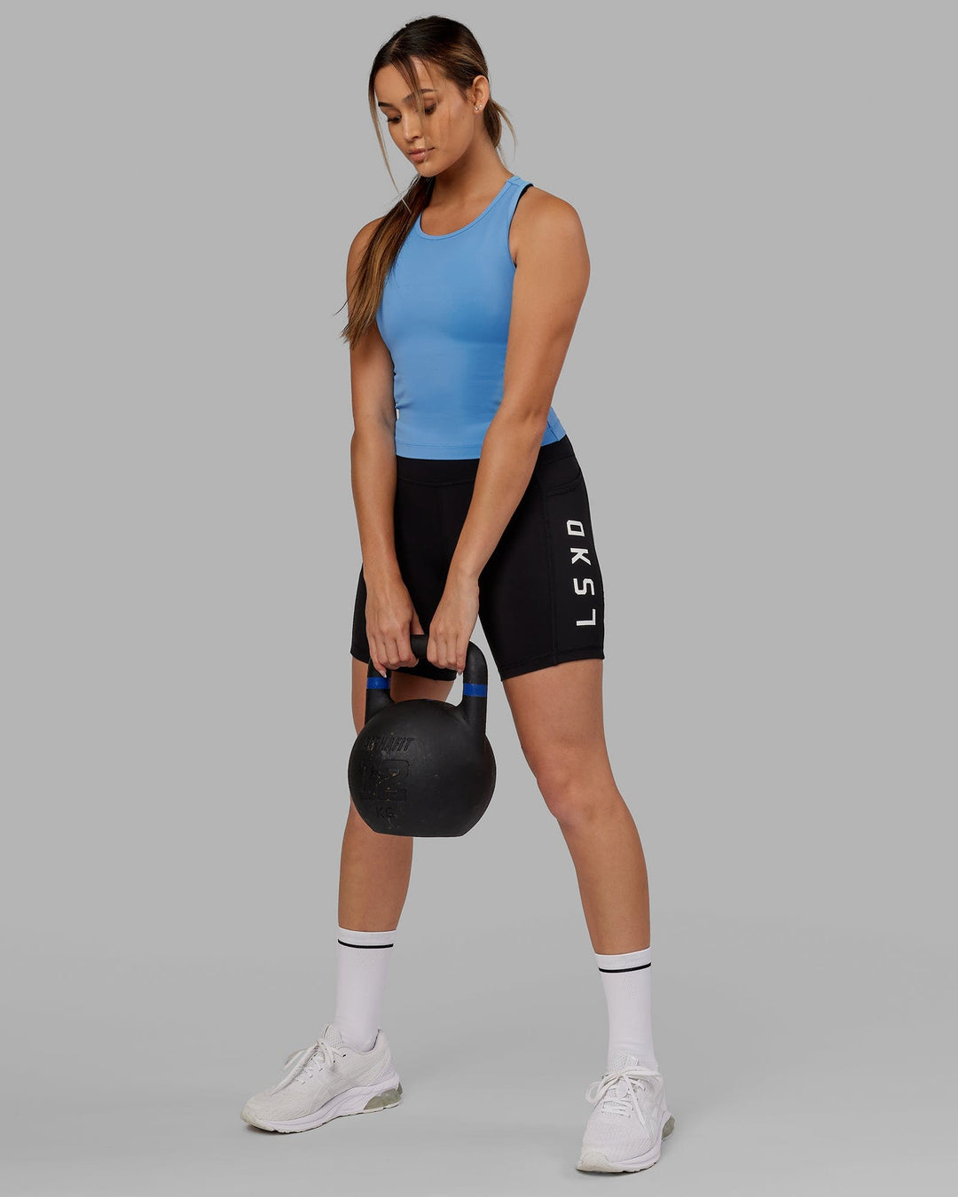 Woman wearing Flow Performance Tank - Azure Blue