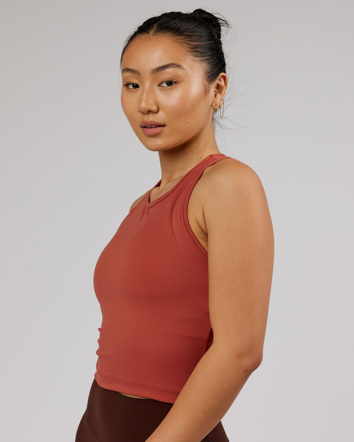 Woman wearing Flow Performance Tank - Marsala