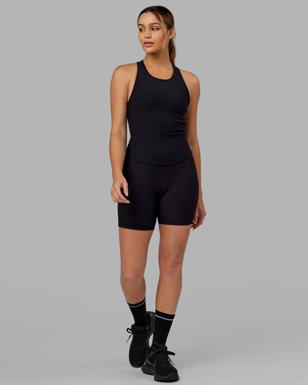 Woman wearing Flow Ribbed Shelf Bra Tank - Black