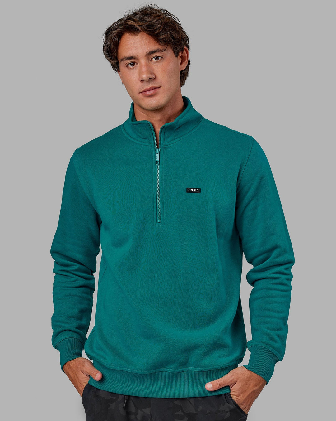 Man wearing Unisex Fundamental 1/4 Zip Sweater - Deep Lake