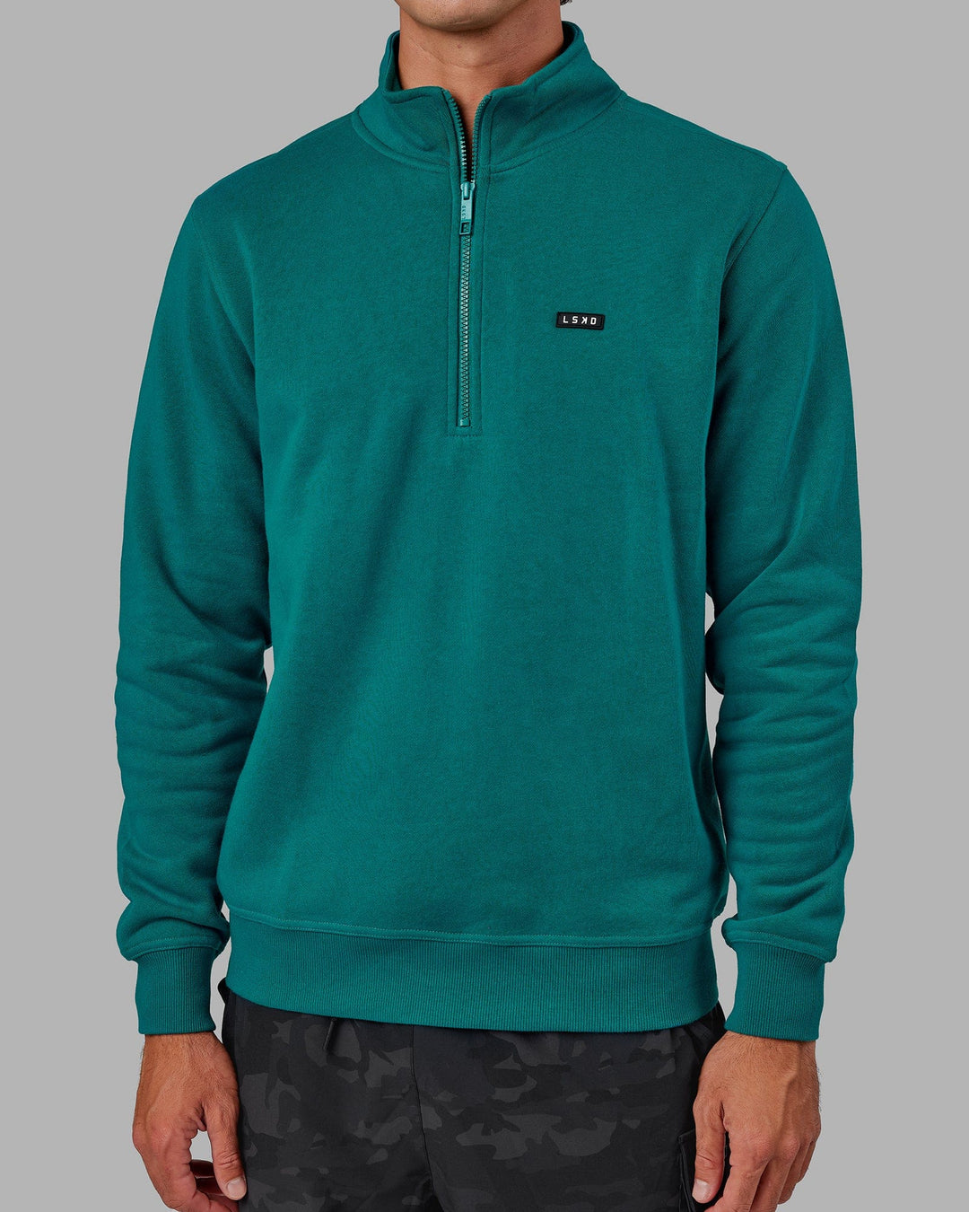 Man wearing Unisex Fundamental 1/4 Zip Sweater - Deep Lake