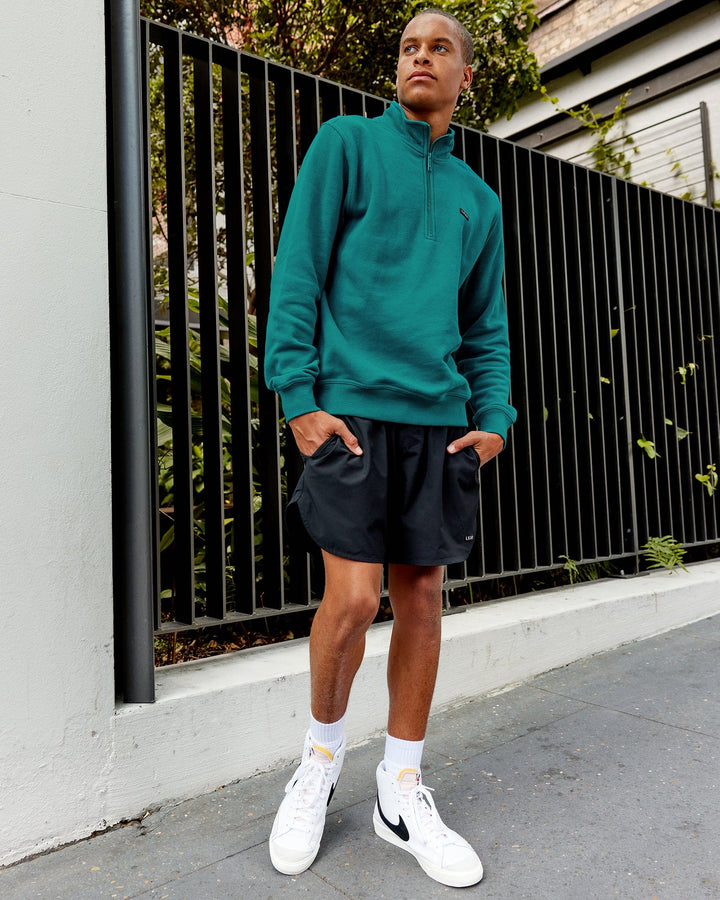 Man wearing Unisex Fundamental 1/4 Zip Sweater - Deep Lake