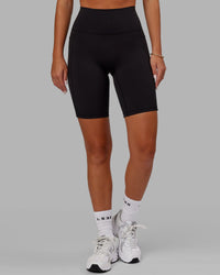 Woman wearing O.G. Fusion Ultra High-Rise 9" Short Pockets - Black | Model:Milly | Size:S