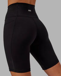 Woman wearing O.G. Fusion Ultra High-Rise 9" Short Pockets - Black | Model:Milly | Size:S