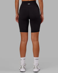 Woman wearing O.G. Fusion Ultra High-Rise 9" Short Pockets - Black | Model:Milly | Size:S