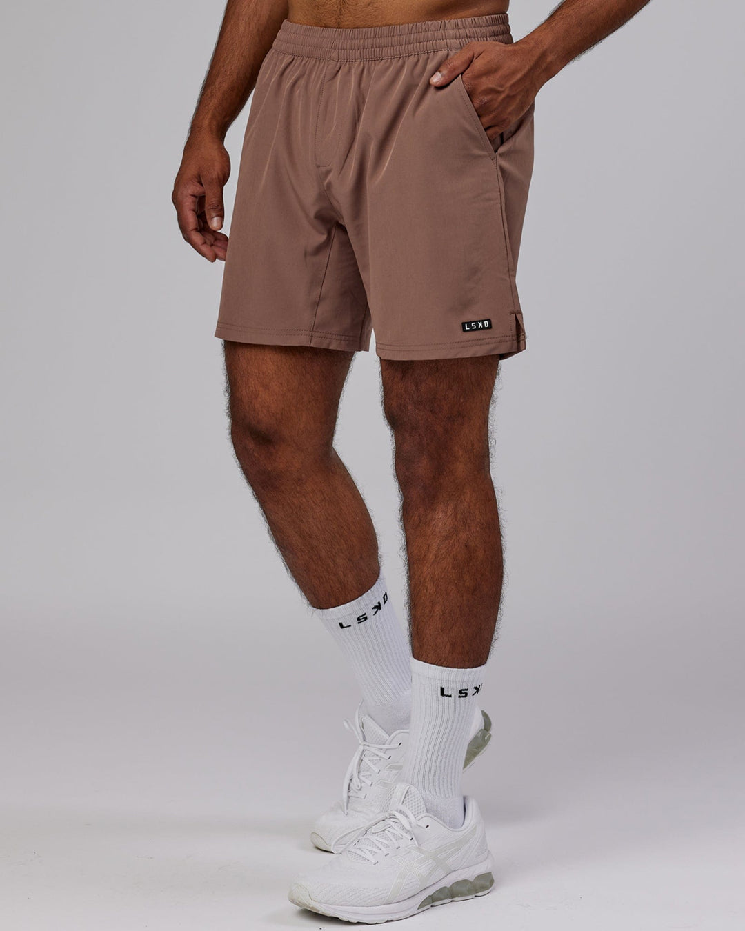 Man wearing Intensity 7'' Performance Short - Deep Taupe