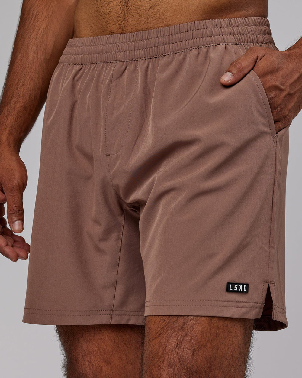 Man wearing Intensity 7'' Performance Short - Deep Taupe