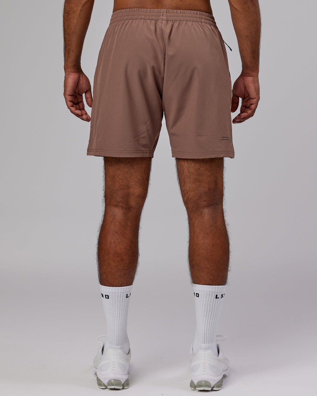 Man wearing Intensity 7'' Performance Short - Deep Taupe