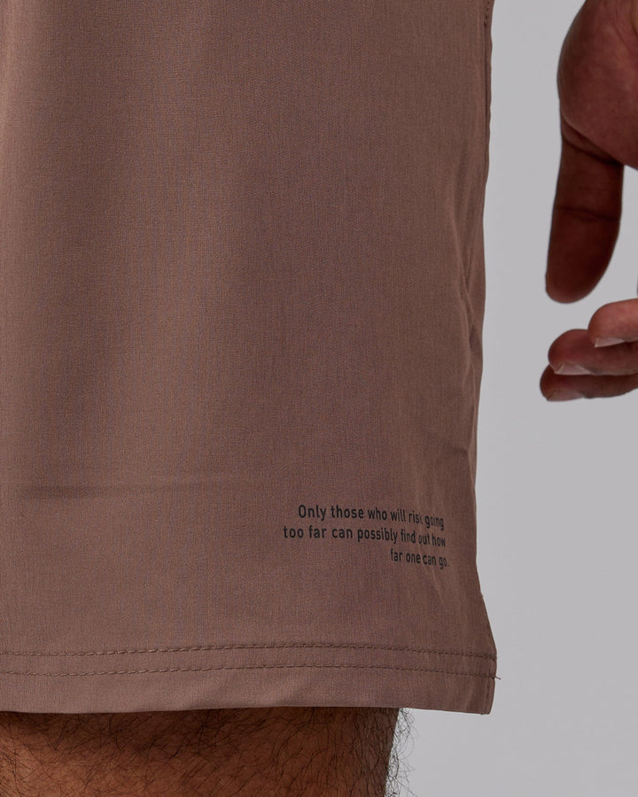 Man wearing Intensity 7'' Performance Short - Deep Taupe