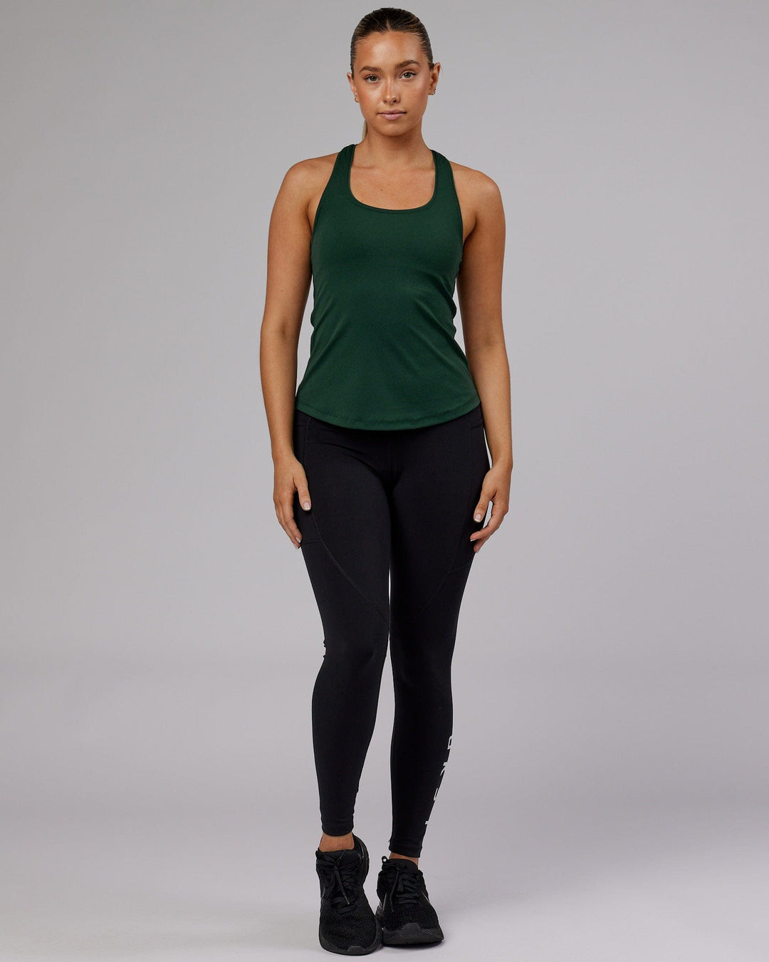 Woman wearing Lift Shelf Bra Performance Tank - Vital Green