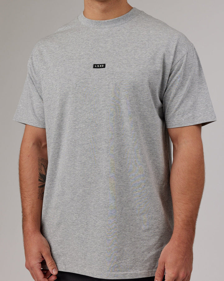 Man wearing Fundamental FLXCotton Tee Longline Oversize - Lt Grey Marl