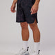 Man wearing Competition 8" Performance Short - Black Camo