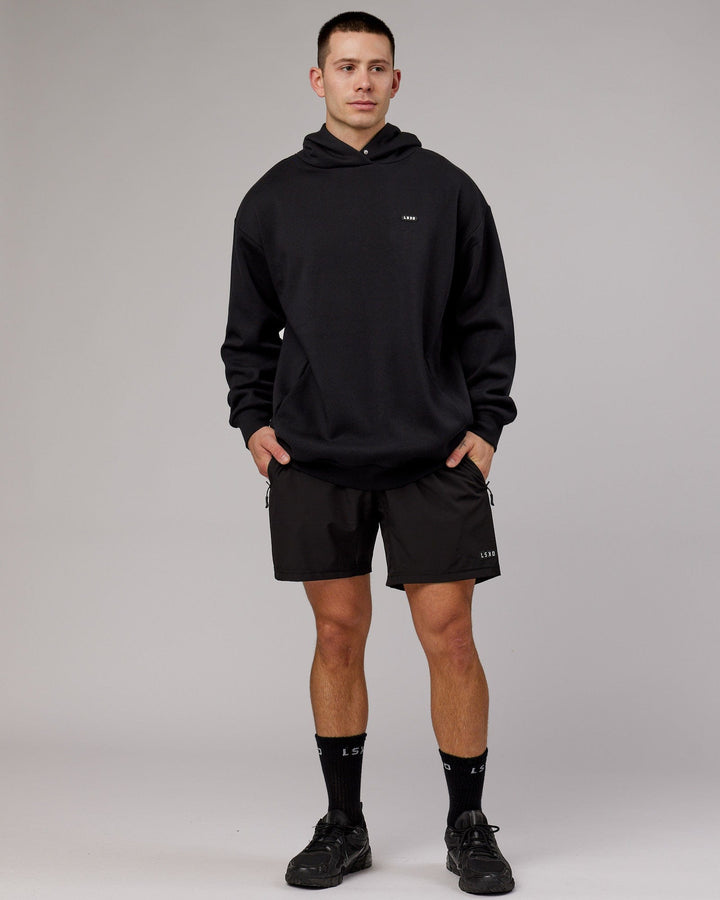 Man wearing Unisex Capsule Hoodie Oversize - Black