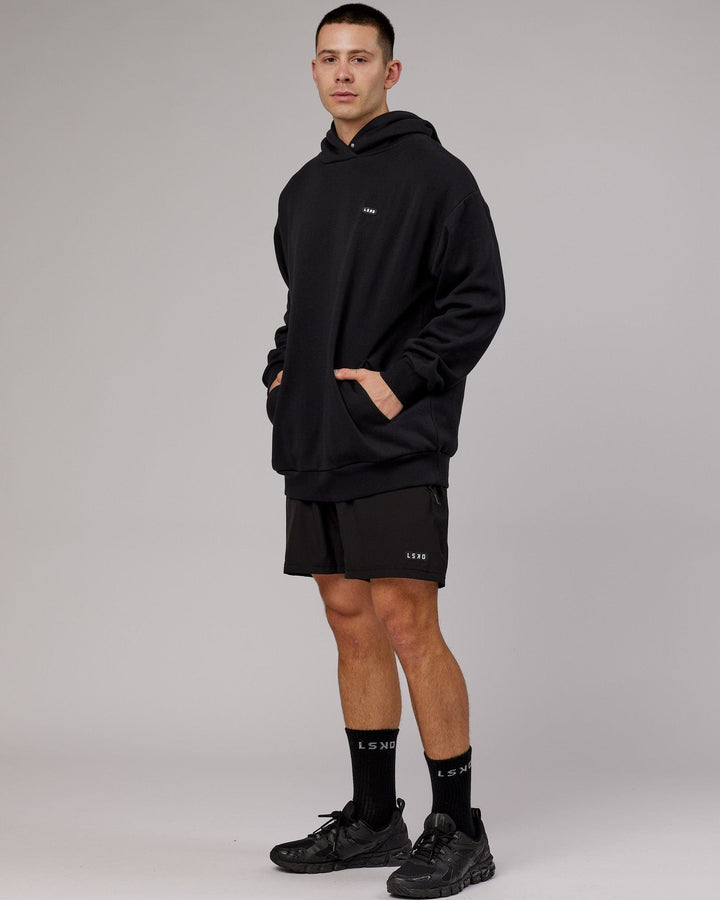 Man wearing Unisex Capsule Hoodie Oversize - Black
