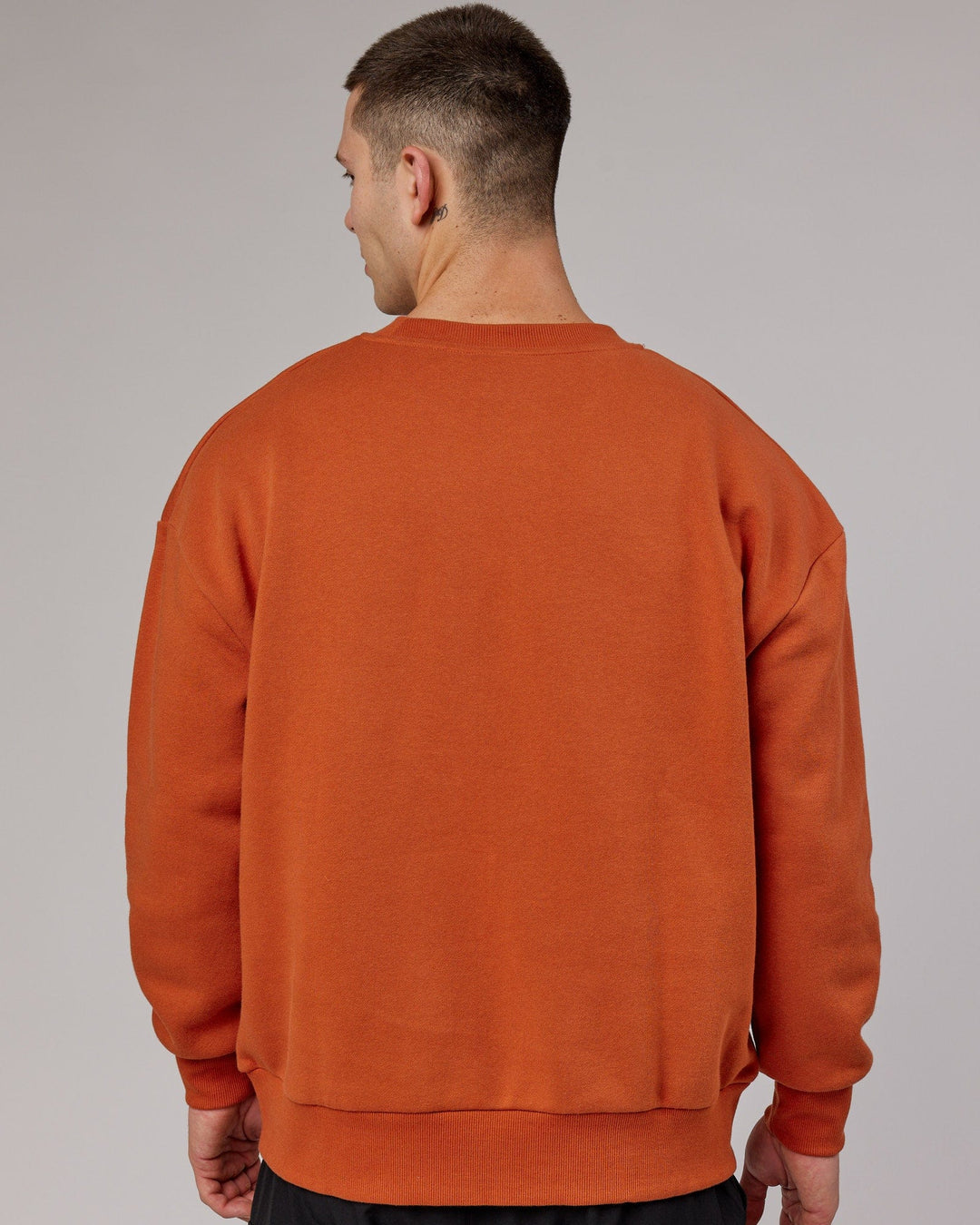 Man wearing Unisex Cornerstone Sweater Oversize - Auburn