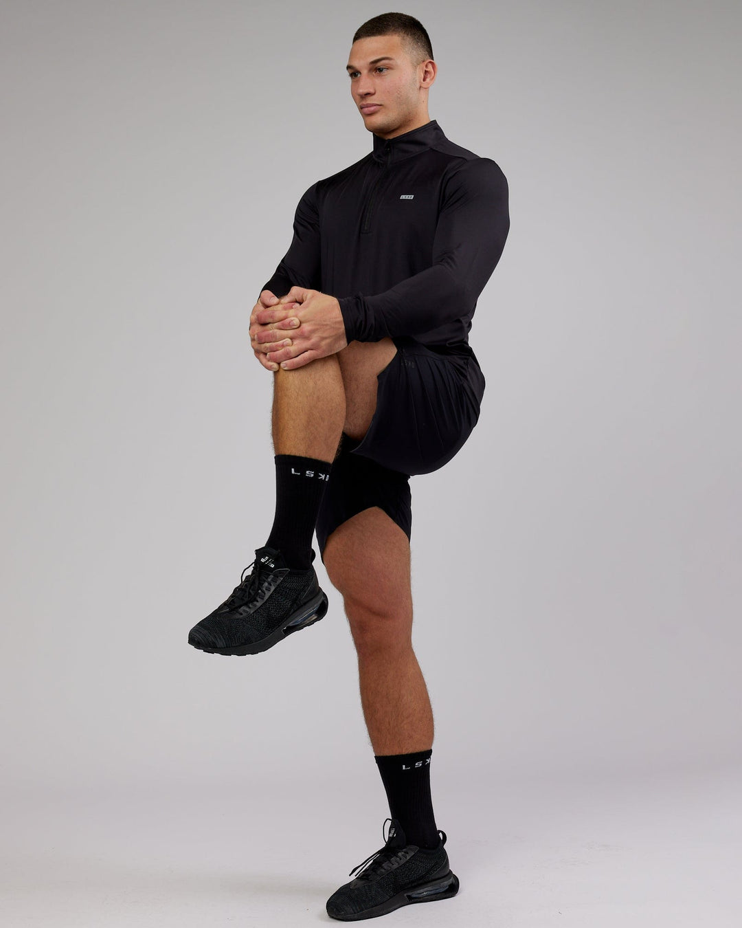 Man wearing Streamlined 1/4 Zip Active Long Sleeve - Black
