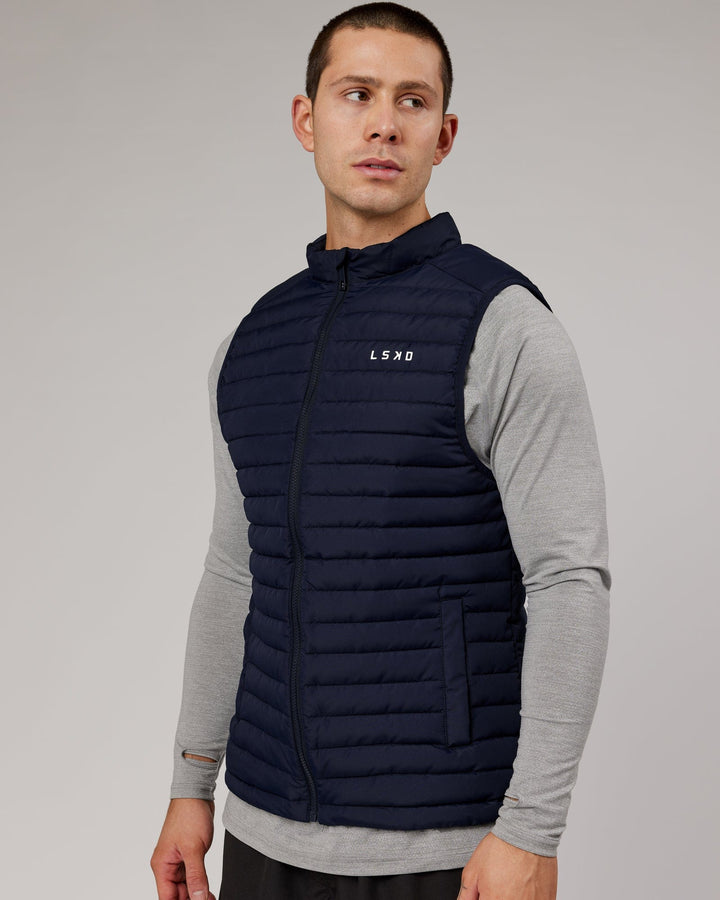 Man wearing Uplift Puffer Vest - Navy