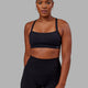 Woman wearing Momentum Sports Bra - Black