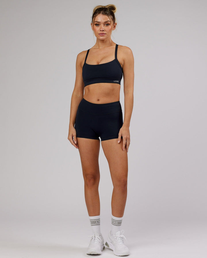 Woman wearing Momentum Sports Bra - Navy