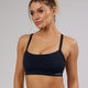 Woman wearing Momentum Sports Bra - Navy