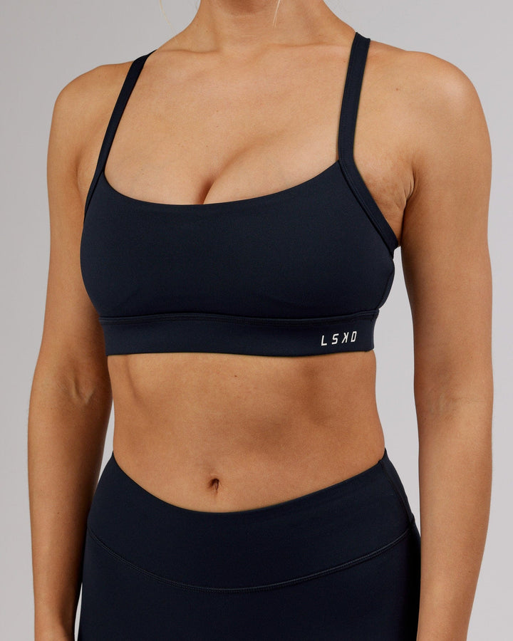 Woman wearing Momentum Sports Bra - Navy
