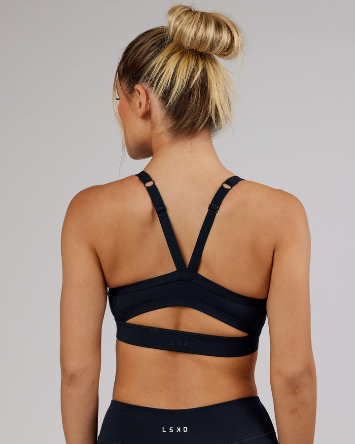 Woman wearing Momentum Sports Bra - Navy