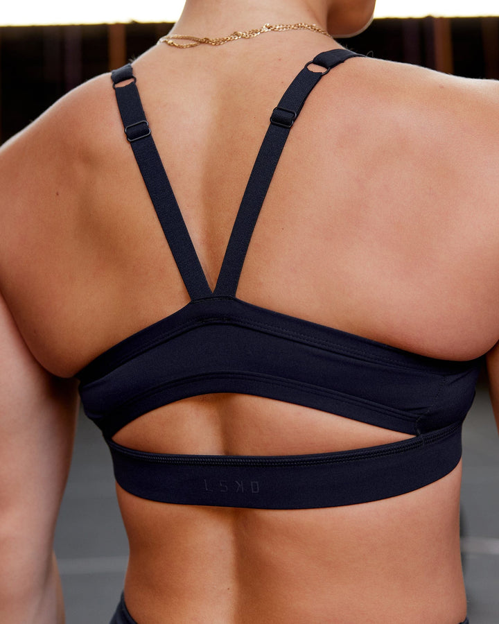 Woman wearing Momentum Sports Bra - Navy