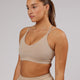 Woman wearing Movement Sports Bra - Taupe