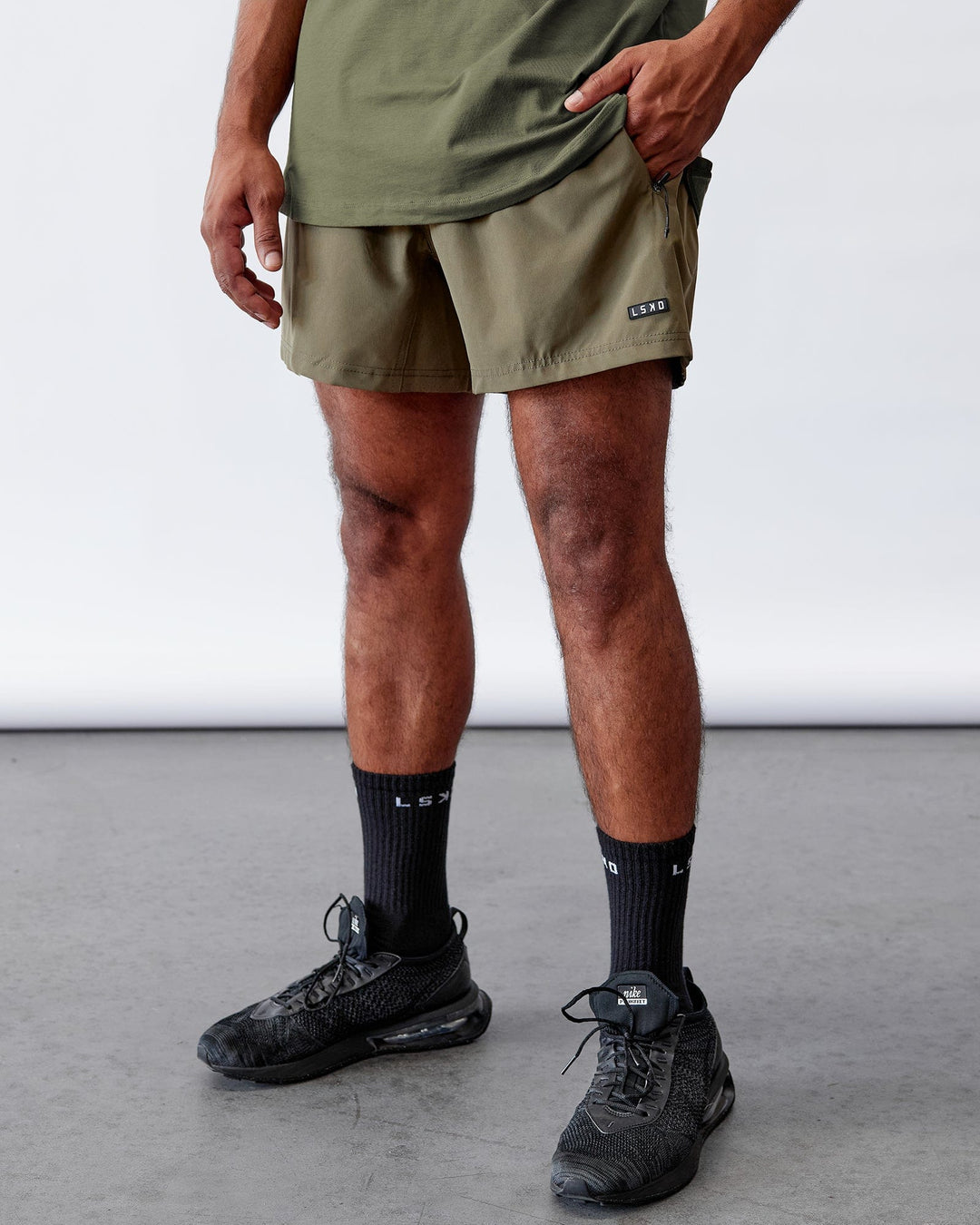 Man wearing Rep 5'' Performance Short - Olive Leaf