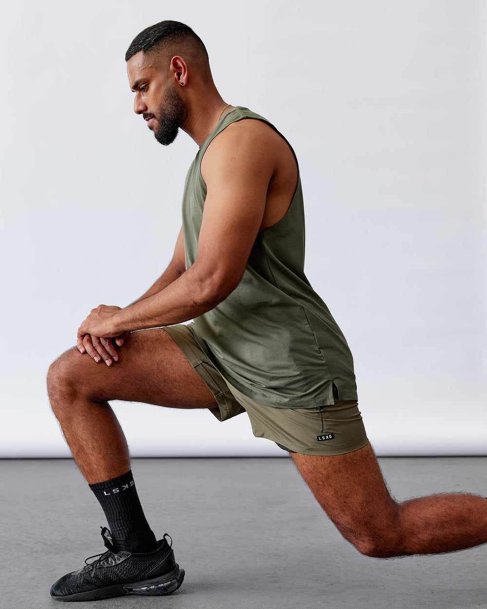 Man wearing Rep 5'' Performance Short - Olive Leaf