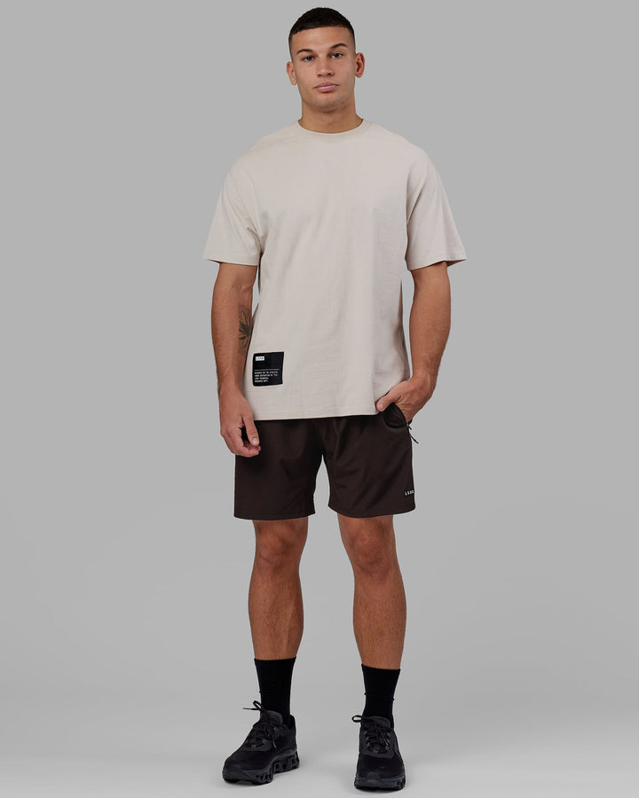 Man wearing Rep 7'' Performance Short - Dark Walnut