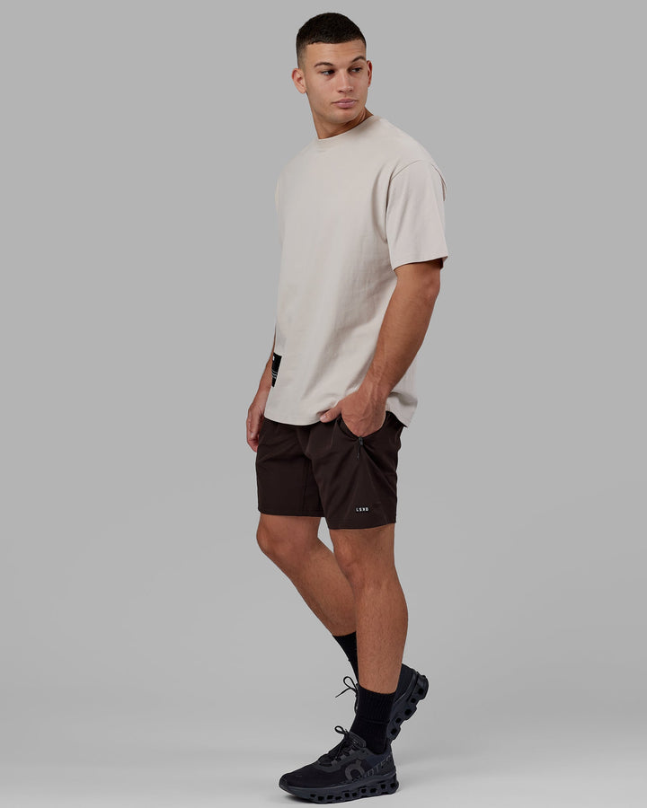 Man wearing Rep 7'' Performance Short - Dark Walnut