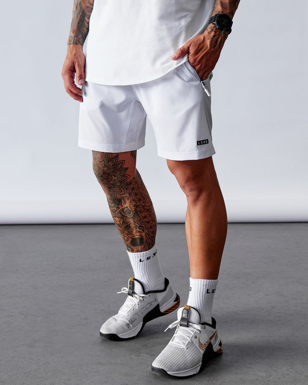 Man wearing Rep 7" Performance Short - White