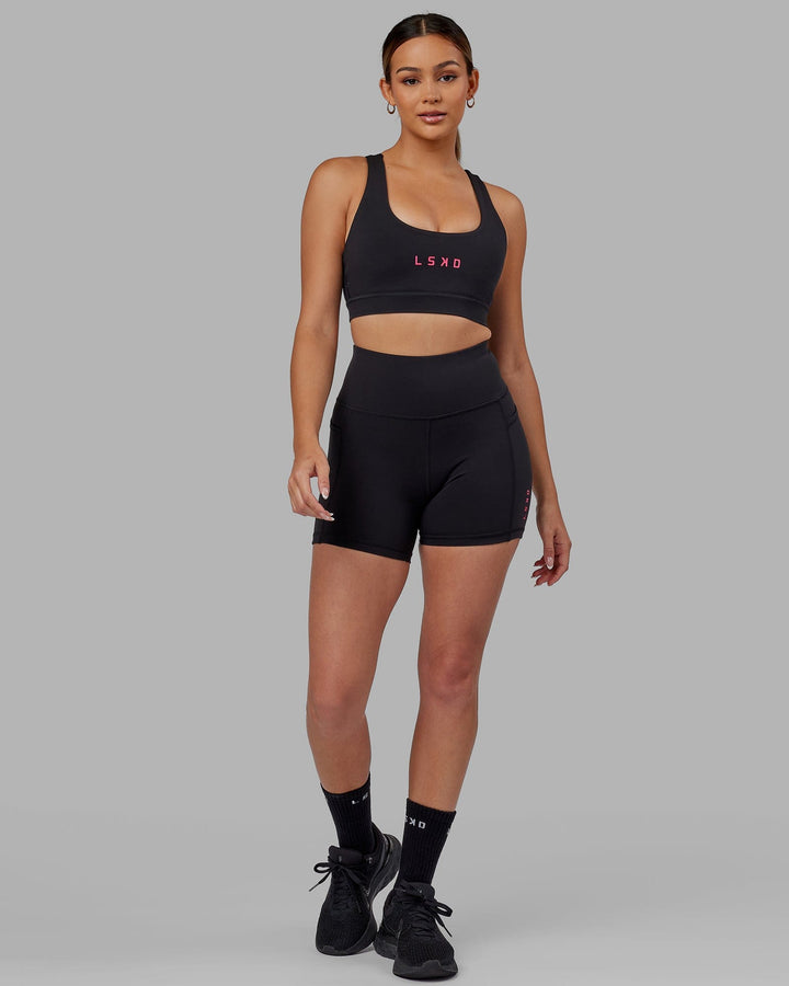 Woman wearing Rep Sports Bra Small Logo - Black-Boysenberry
