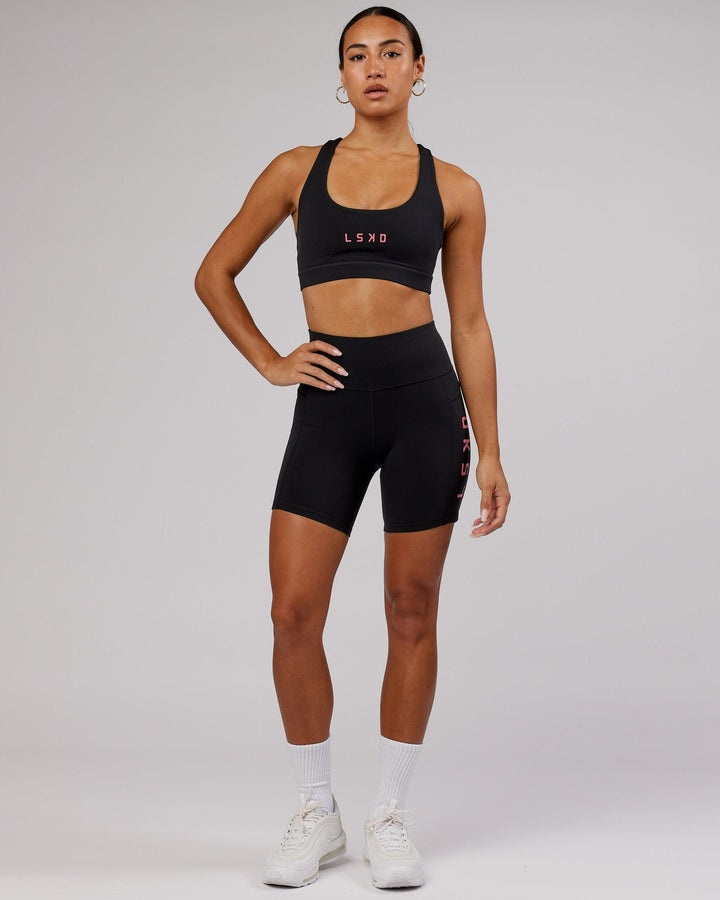 Woman wearing Rep Sports Bra Small Logo - Black-Flamingo