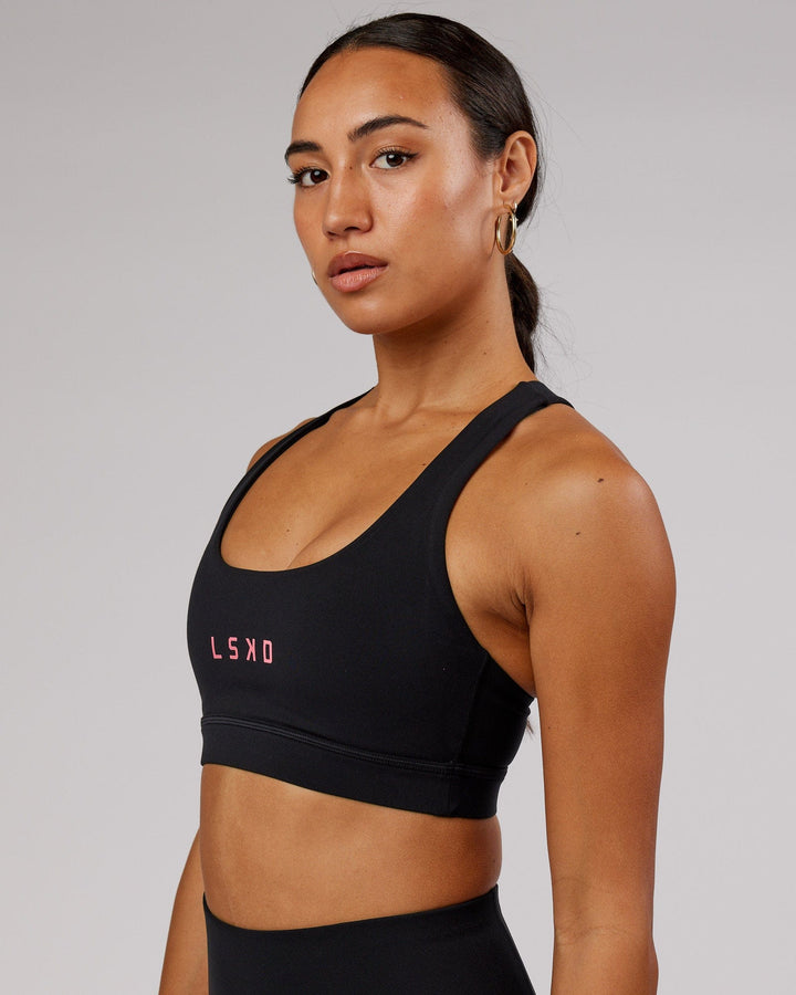 Woman wearing Rep Sports Bra Small Logo - Black-Flamingo