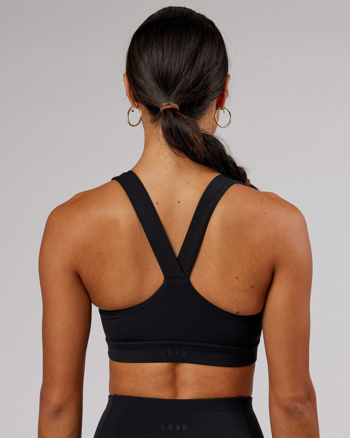 Woman wearing Rep Sports Bra Small Logo - Black-Flamingo