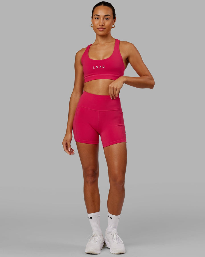 Woman wearing Rep Sports Bra Small Logo - Boysenberry
