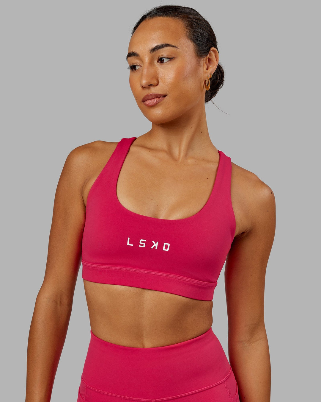 Woman wearing Rep Sports Bra Small Logo - Boysenberry