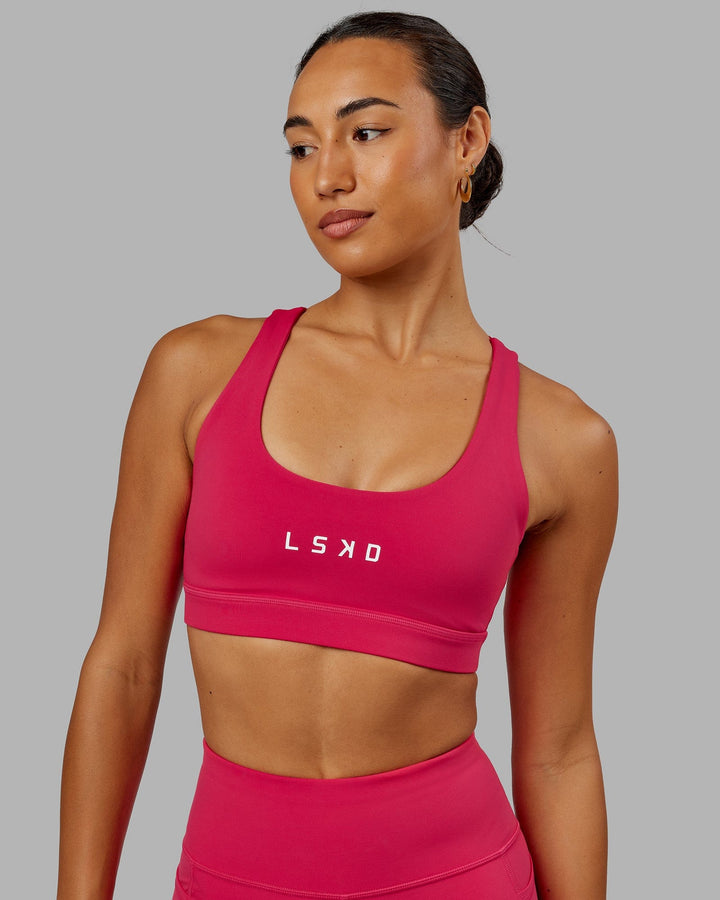 Woman wearing Rep Sports Bra Small Logo - Boysenberry