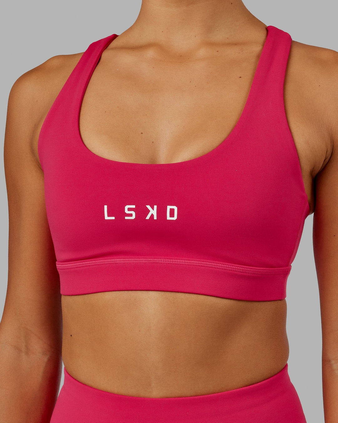 Woman wearing Rep Sports Bra Small Logo - Boysenberry
