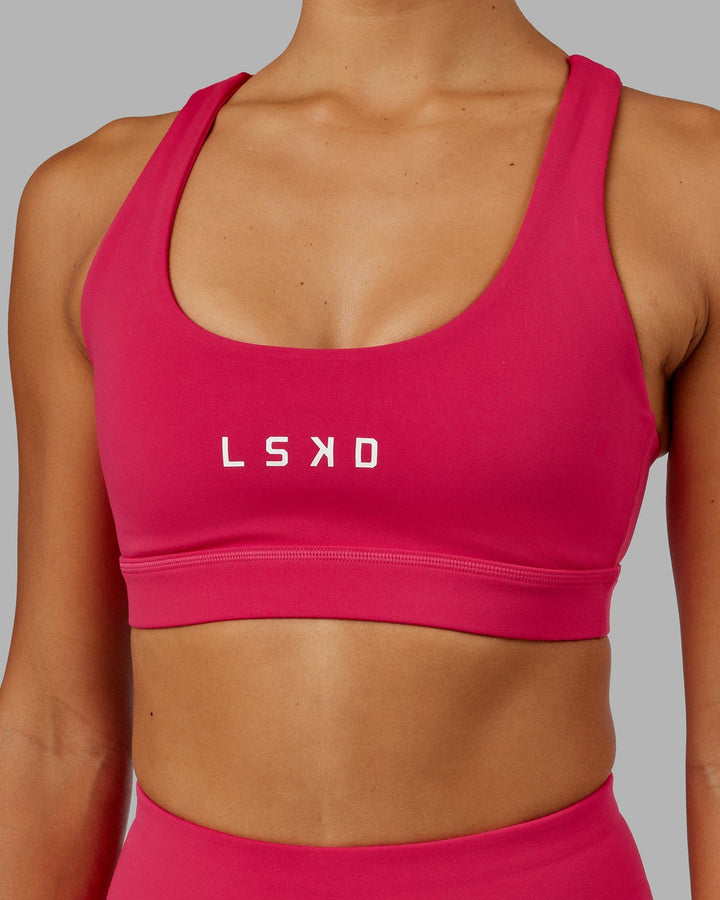 Woman wearing Rep Sports Bra Small Logo - Boysenberry